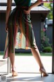 A woman standing in front of a sliding glass door.