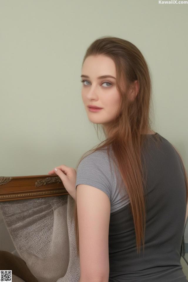 A woman with long brown hair sitting on a chair.